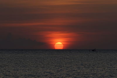 Scenic view of sea against romantic sky at sunset