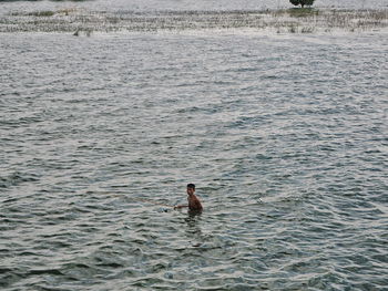 High angle view of man swimming in sea