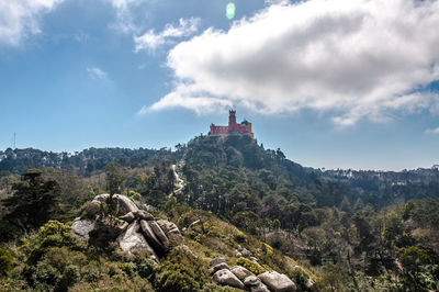 Scenic view of building and mountains against sky