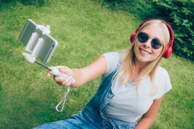 High angle view of smiling young woman wearing sunglasses