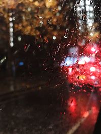 Close-up of wet car window in rainy season