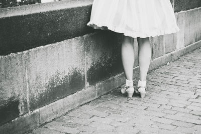 Woman standing on footpath