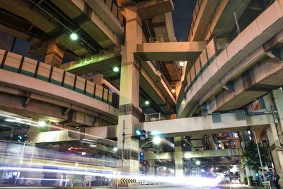 Low angle view of illuminated street lights at night