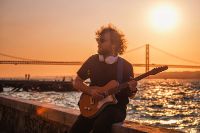 Street musician playing electric guitar in the street