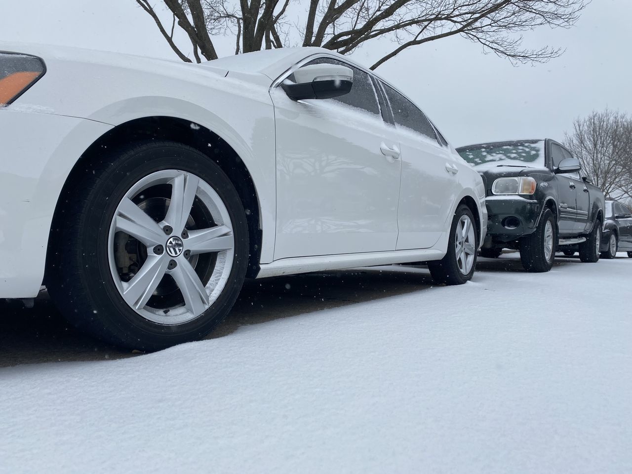 CAR ON SNOW COVERED ROAD