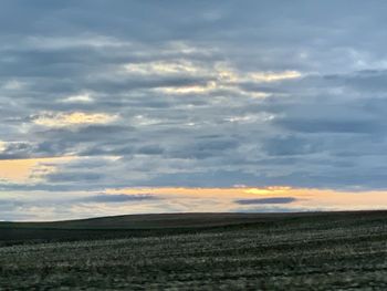 Scenic view of field against sky during sunset