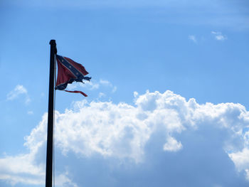 Low angle view of poles against blue sky