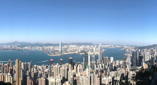 Panoramic view of city and buildings against clear blue sky