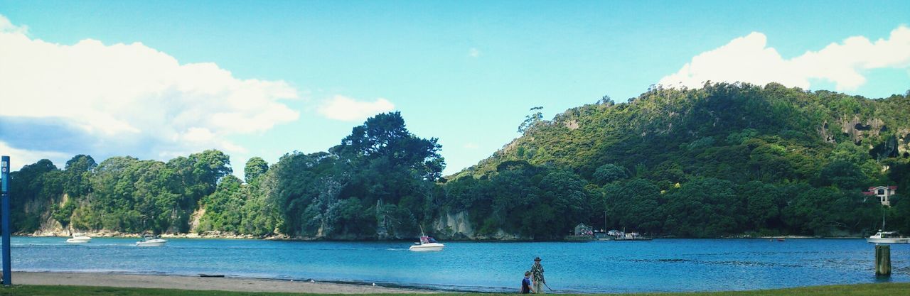 water, tree, sky, nautical vessel, mountain, transportation, boat, sea, scenics, mode of transport, tranquil scene, tranquility, beauty in nature, nature, cloud - sky, blue, cloud, incidental people, vacations, travel