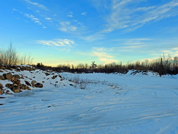 Scenic view of snow covered landscape against sky