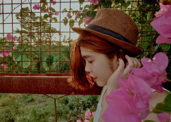 Young woman by flowering plant