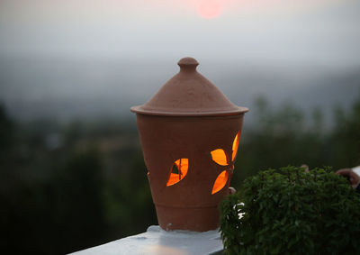 Close-up of illuminated pumpkin against orange sky