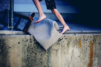 Low section of person running on retaining wall