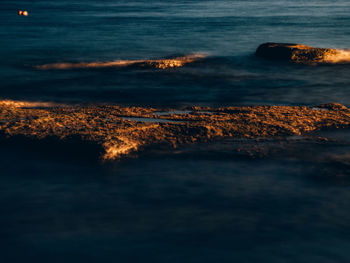 Aerial view of sea against sky during sunset