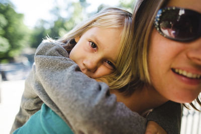 Portrait of daughter having piggyback ride on mother