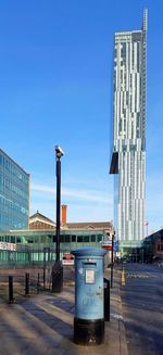 View of buildings against clear blue sky