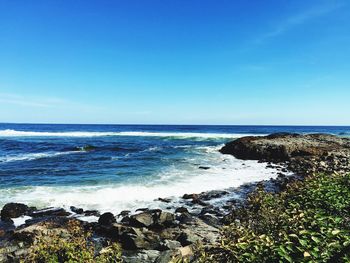 Scenic view of sea against clear blue sky