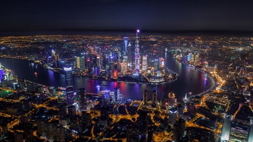 Aerial view of illuminated city at night