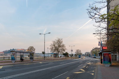 Empty road against sky in city