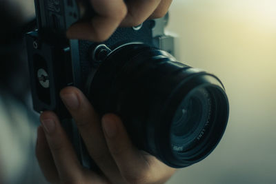 Cropped image of woman holding camera