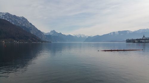 Scenic view of lake and mountains against sky