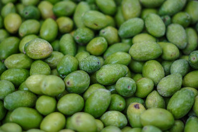 Full frame shot of green lemons in market