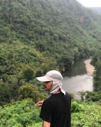 Side view of man standing against mountain