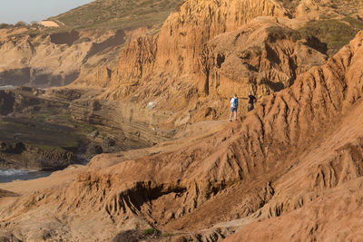 Hikers standing on rocky mountain