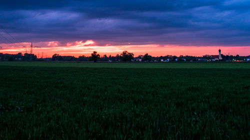 Scenic view of field against cloudy sky