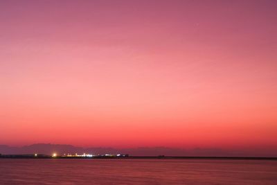 Scenic view of sea against romantic sky at sunset