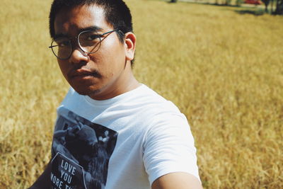 Portrait of young man in field