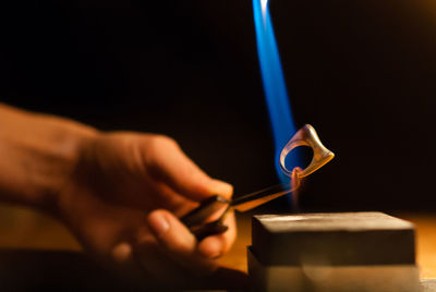 Cropped hand of person working at workshop