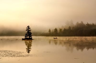 Scenic view of lake against sky during sunset