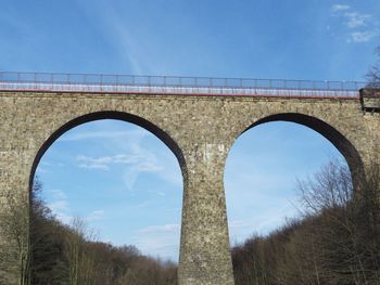Low angle view of arch bridge against sky