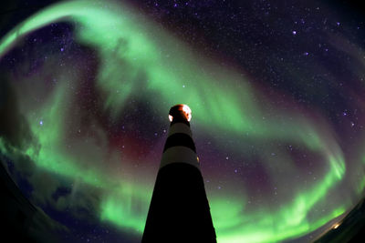 Low angle view of illuminated tower against sky at night