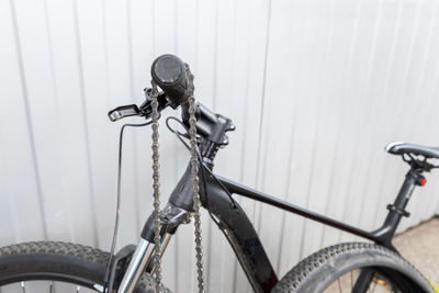 Close-up of bicycle against wall