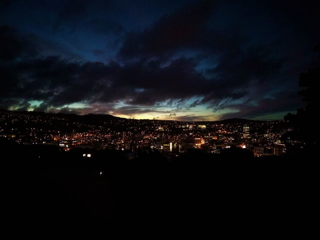 ILLUMINATED BUILDINGS AGAINST SKY AT NIGHT