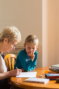 Boy sitting on table