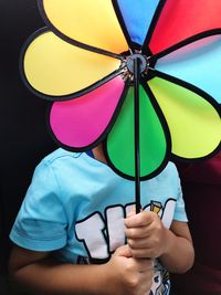 Close-up of boy holding pinwheel toy