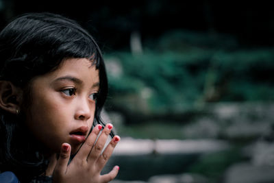 Close-up portrait of girl looking away