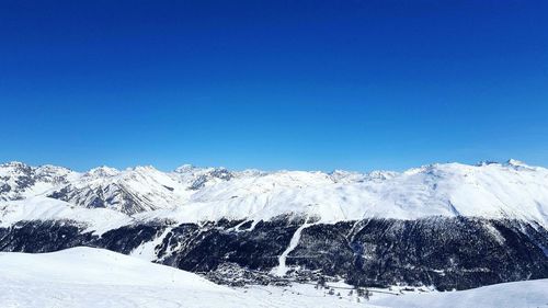 Idyllic shot of snowcapped mountains against clear blue sky