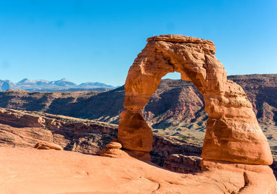 View of rock formations against clear blue sky