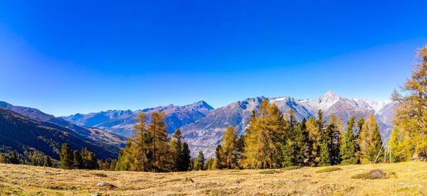 Scenic view of mountains against clear blue sky