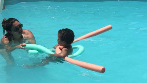 Mother and son playing in swimming pool