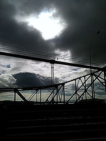 cloud - sky, sky, cloudy, weather, water, silhouette, nature, cloud, railing, overcast, tranquility, connection, scenics, beauty in nature, low angle view, dusk, tranquil scene, sunset, dramatic sky, outdoors