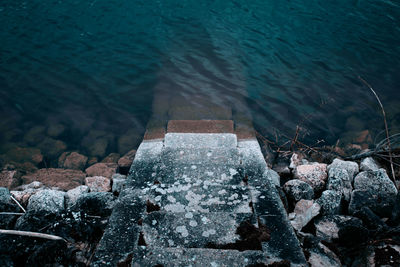 High angle view of rocks by sea