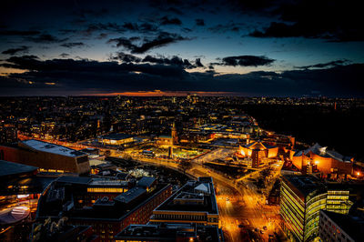 High angle view of illuminated cityscape against sky at night