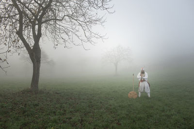 People on field during foggy weather