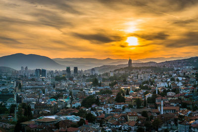 Aerial view of townscape against sky during sunset