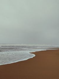 Scenic view of beach against clear sky